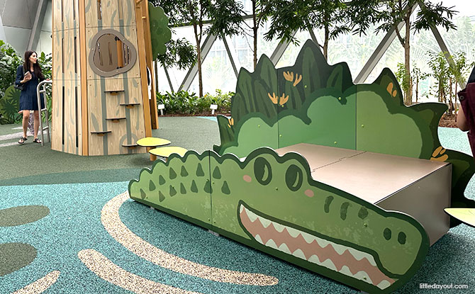 Crocodile-shaped climbing ramp and wooden treehouse at Jewel Changi Airport West Gateway Playground.