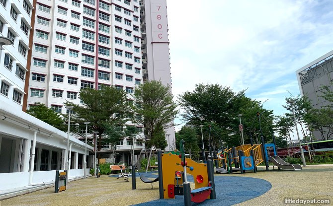 Low play structures, a swing and a slide beside Block 780C at Woodlands Glade.