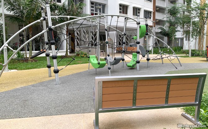 Ropes and suspended climbing seats on a curved metal frame at Woodlands Glade.