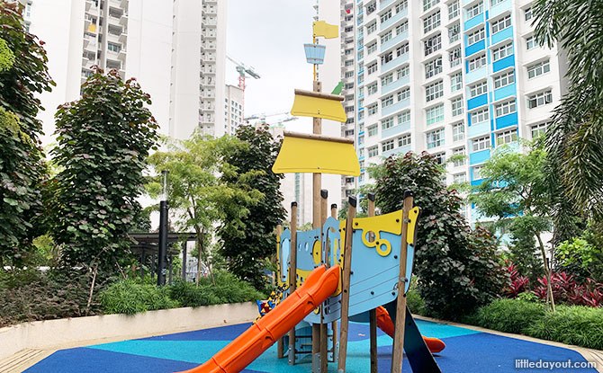 Blue and yellow ship playground with orange slide at Northshore StraitsView.