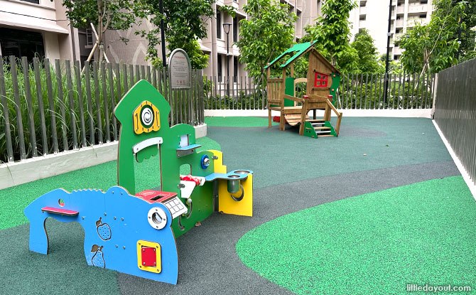 Gated toddler play area with a green-roofed playhouse at Plantation Village near Block 126B.