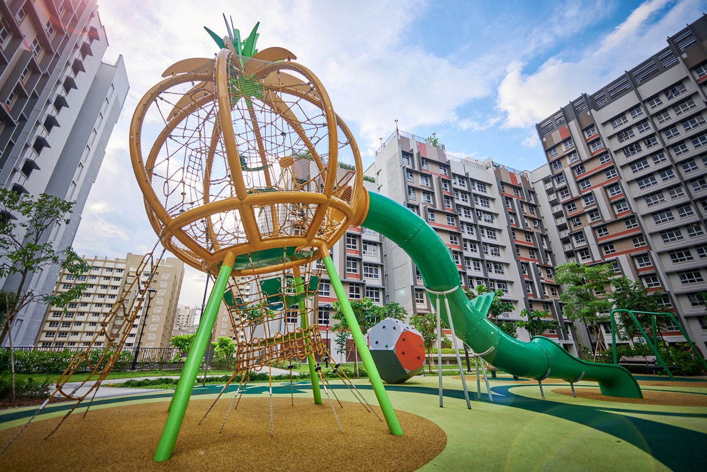 Pineapple-shaped climbing tower and green slide at Plantation Grange's Ong Lye Garden