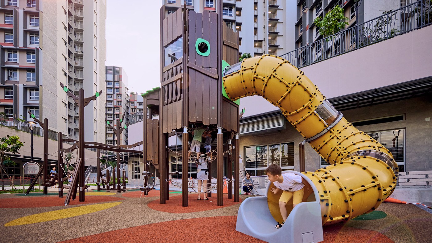 Brown Cocoaland treehouse and yellow tube slide in front of Plantation Grange Block 131B