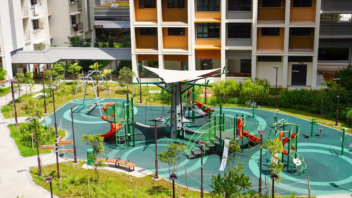 Branch Out climbing structure, ropes and slides on the green play court at Plantation Acres.