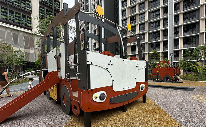 A truck-themed climbing and slide structure near Block 963B.