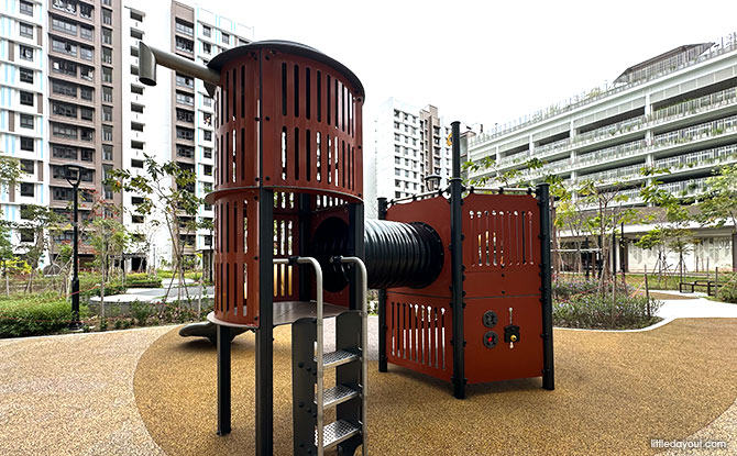 Low red play towers and slides at the GreenEmerald toddler court near Block 961B.