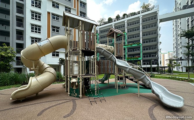 Nature-themed twin play towers with a connecting tunnel and slides in front of Yishun Glen Block 382C