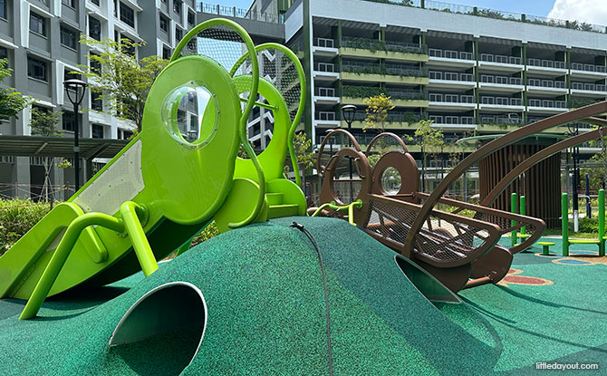 Green grasshopper slide and brown cricket climbing structure at Yishun Boardwalk.