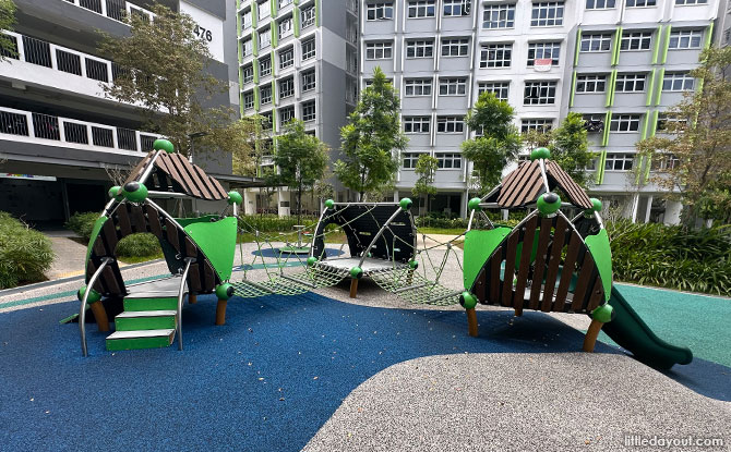 Low green slides and small play houses at the Melody Spring toddler court.