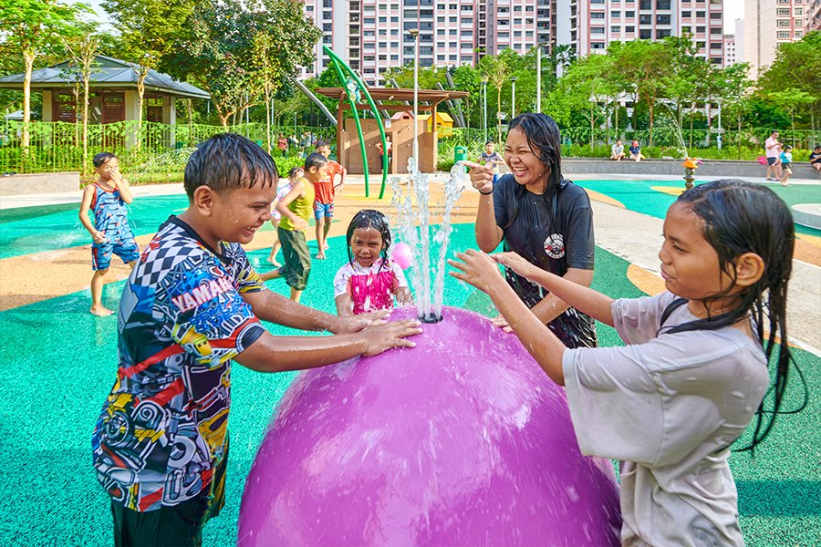 Children using a water-play feature at Buangkok Square Park