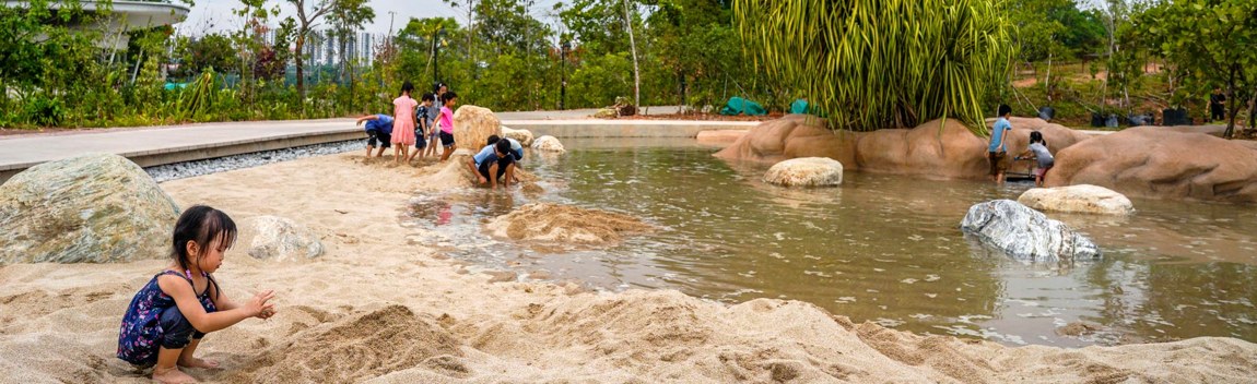 Children exploring the shallow water-play channels at Clusia Cove